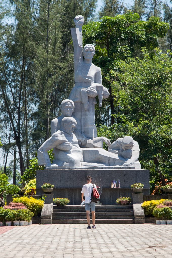 Noah in front of the My Lai memorial statue